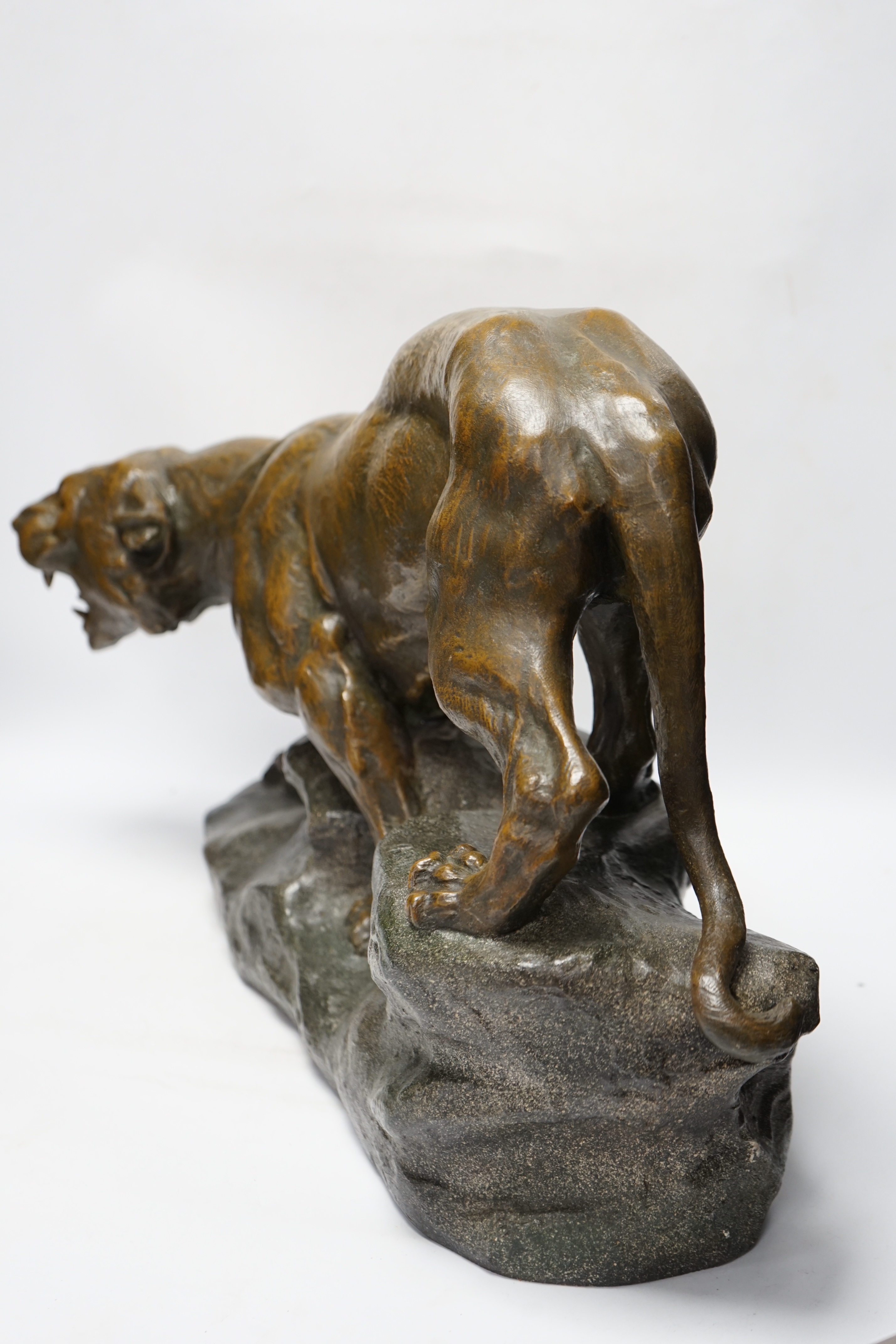 A patinated spelter model of a panther, signed Cartier, approx. 62cm wide